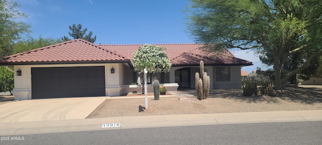 13916 W Whitewood Dr, Sun City West, AZ 85375 - mediterranean / spanish-style home featuring a tiled roof, concrete driveway, an attached garage, and stucco siding