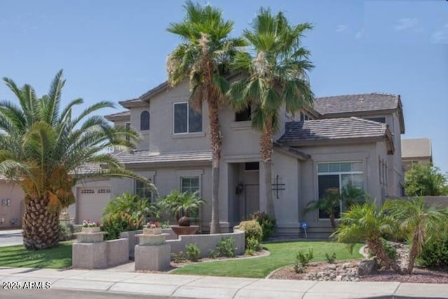 view of front facade with a garage and a front yard