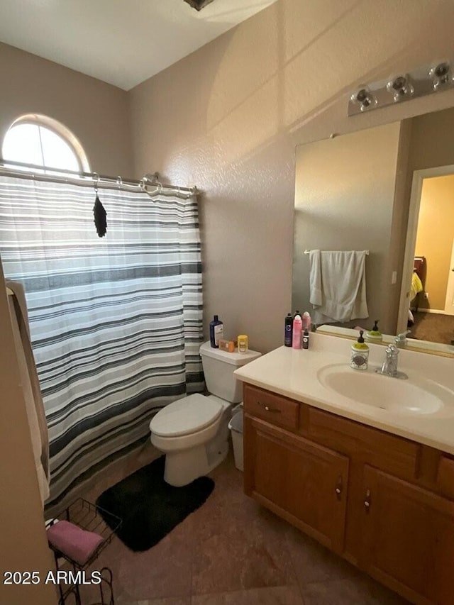 bathroom featuring vanity, tile patterned floors, and toilet