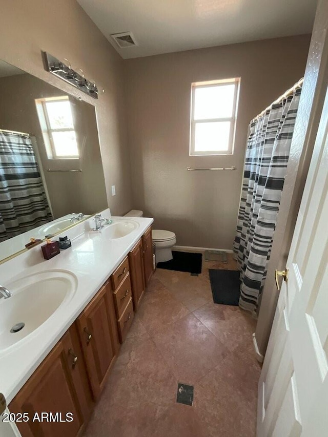 bathroom with tile patterned flooring, vanity, curtained shower, and toilet