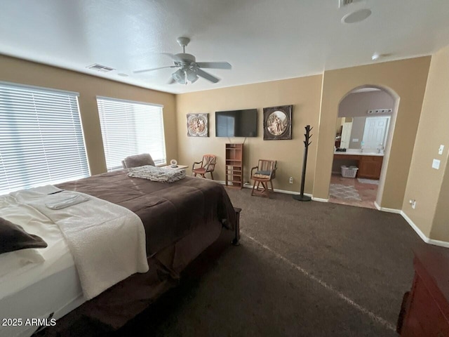 carpeted bedroom featuring ceiling fan and ensuite bathroom