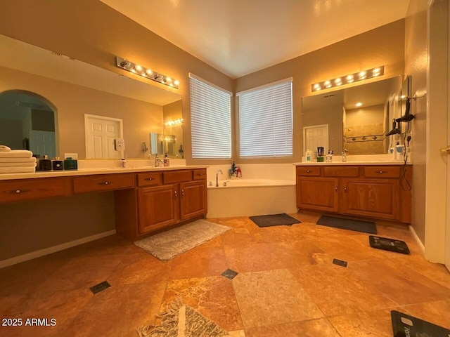 bathroom with vanity and shower with separate bathtub