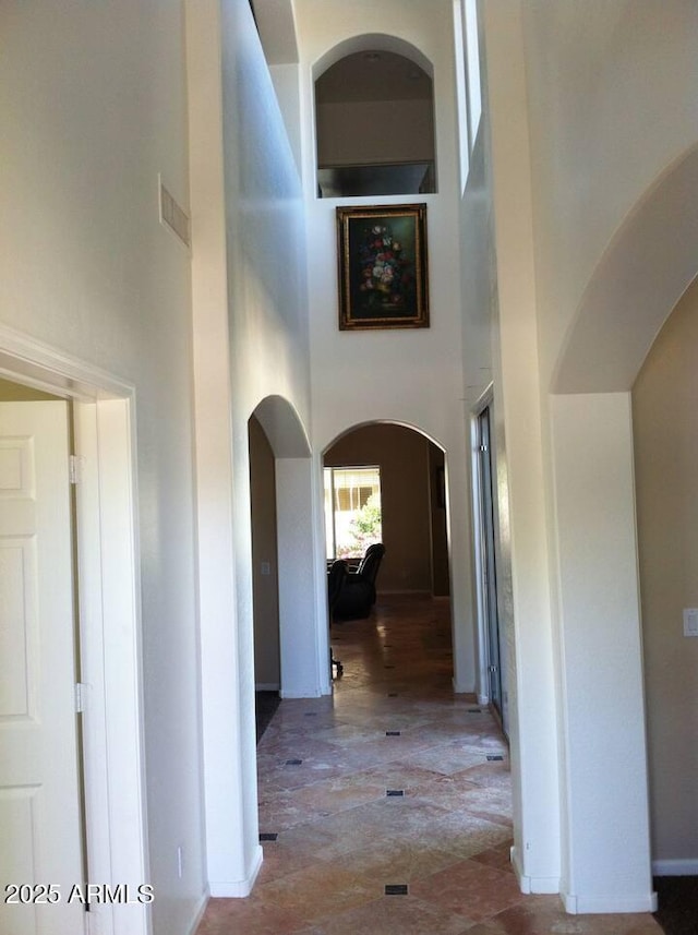 corridor featuring a high ceiling