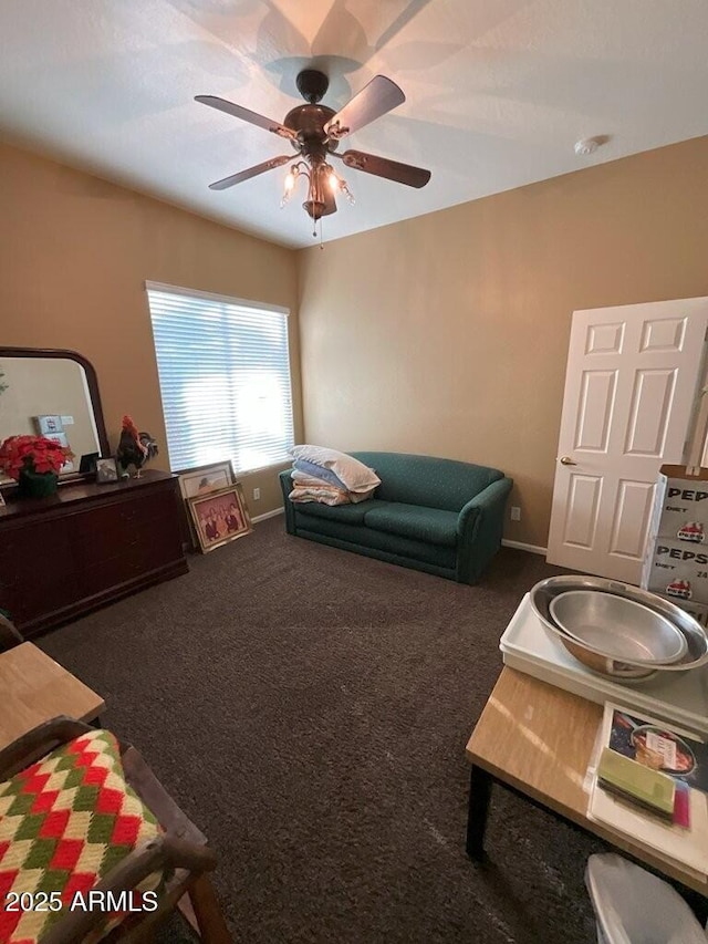 living room featuring ceiling fan and dark carpet