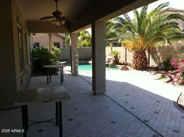 view of patio / terrace featuring a fenced in pool and ceiling fan