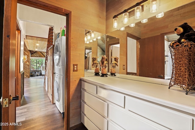 4511 N Ponderosa Dr, Pine, AZ 85544 - bathroom featuring estacked washer and dryer, wood walls, wood finished floors, and vanity