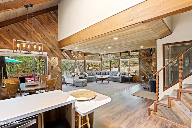 4511 N Ponderosa Dr, Pine, AZ 85544 - living room featuring wooden walls, high vaulted ceiling, stairs, wooden ceiling, and wood finished floors