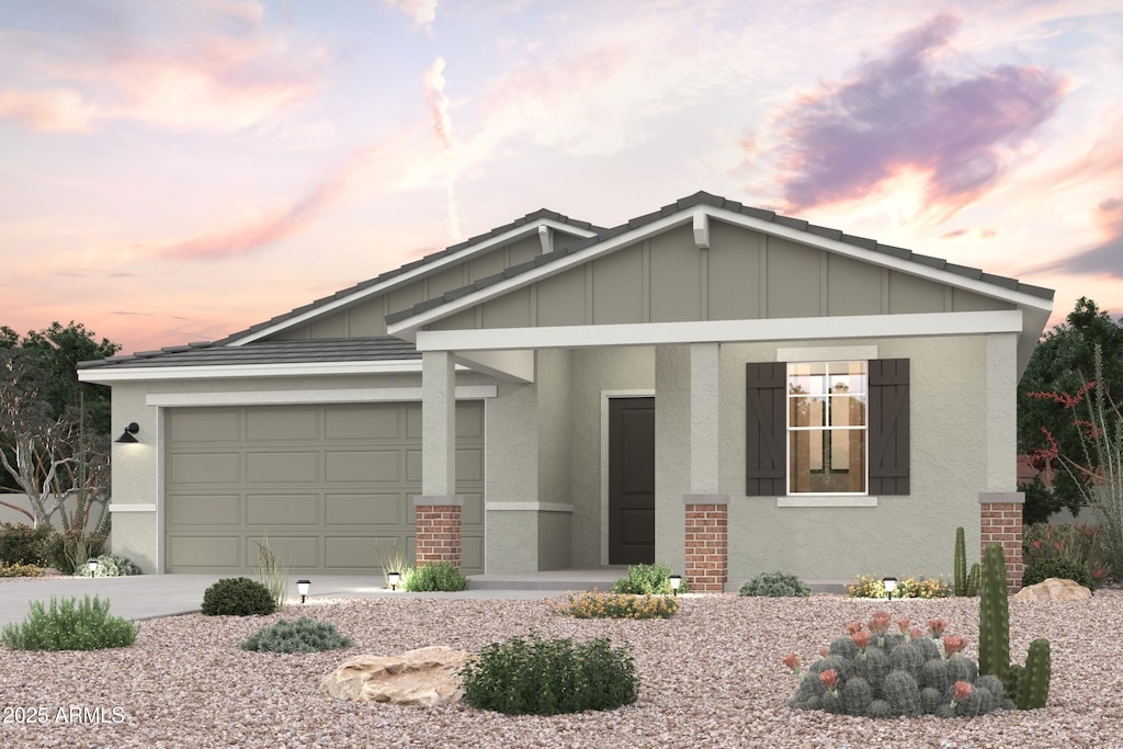 craftsman inspired home with concrete driveway, a garage, stucco siding, and board and batten siding