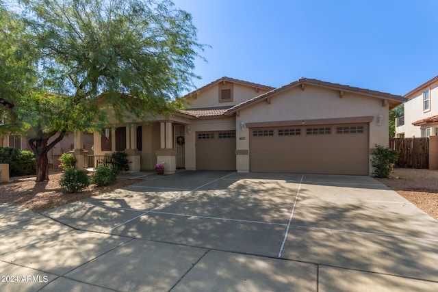 view of front of property with a porch and a garage