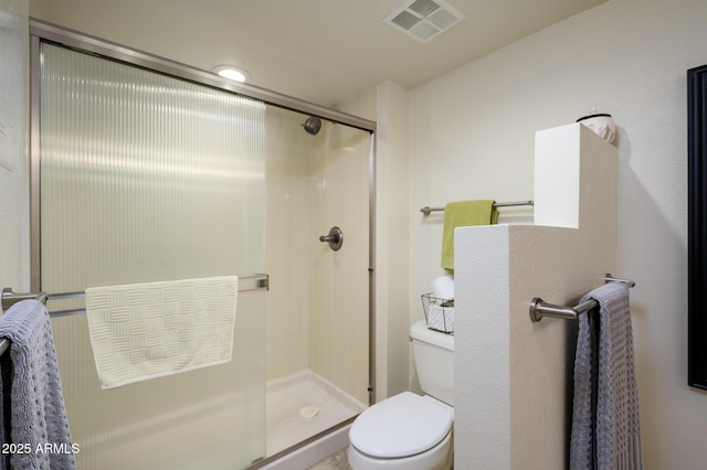 full bath featuring visible vents, toilet, and a stall shower