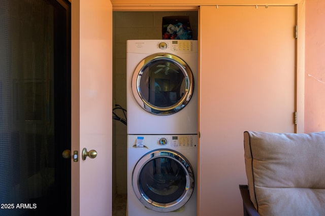 washroom with laundry area and stacked washing maching and dryer