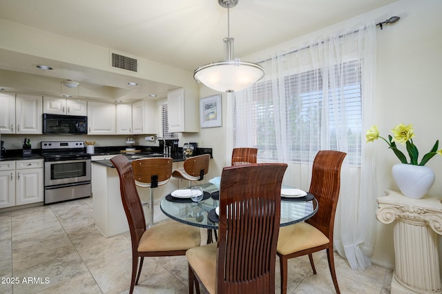 dining room featuring visible vents