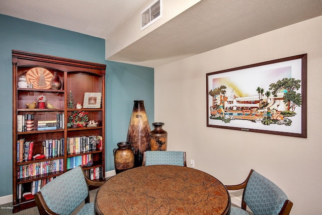 dining space featuring baseboards and visible vents