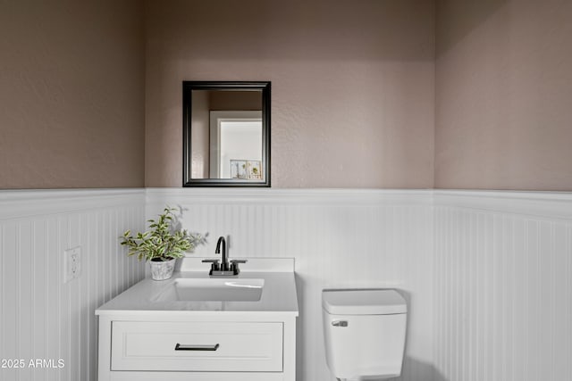 bathroom with toilet and vanity