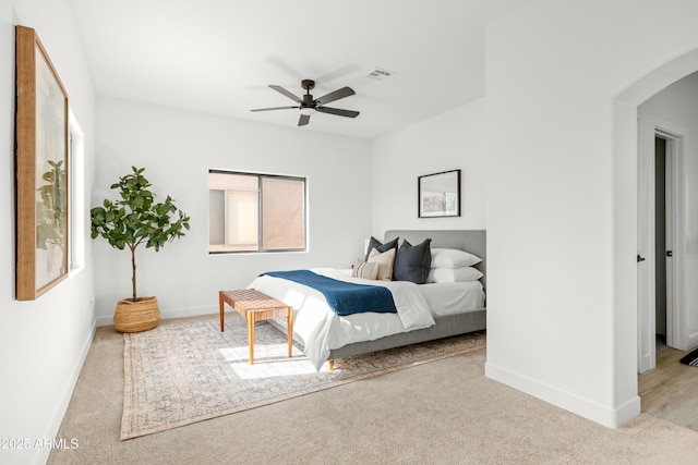 bedroom with light carpet and ceiling fan