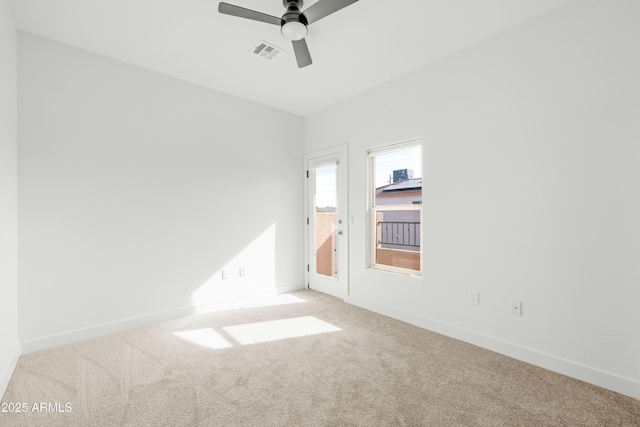 spare room featuring ceiling fan and carpet flooring