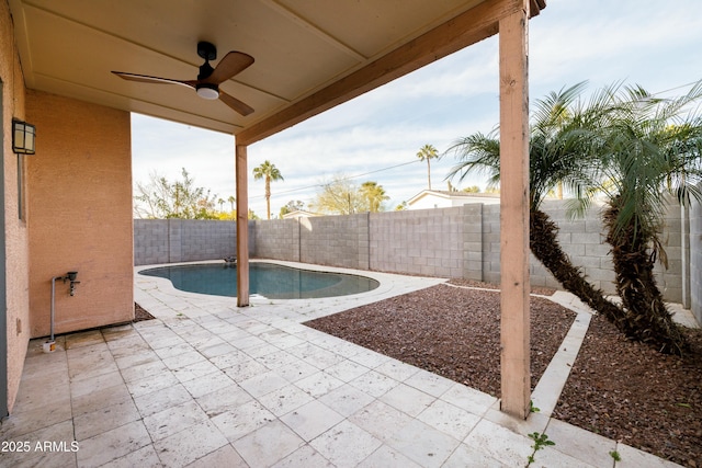 view of patio featuring a fenced in pool and ceiling fan