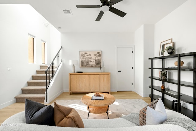 living room with light hardwood / wood-style floors and ceiling fan