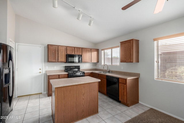 kitchen with a sink, a kitchen island, vaulted ceiling, light countertops, and black appliances