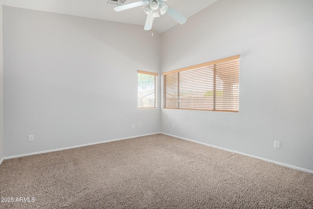 empty room with baseboards, visible vents, lofted ceiling, ceiling fan, and carpet flooring