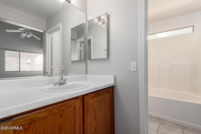 bathroom with ceiling fan, shower / bathing tub combination, vanity, and tile patterned floors