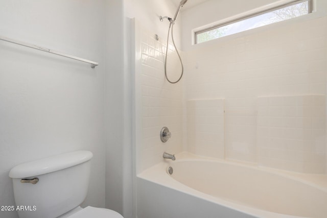 bathroom featuring shower / bathtub combination and toilet