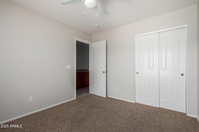 unfurnished bedroom with a closet, carpet flooring, and baseboards