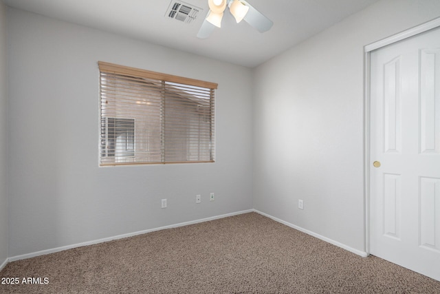 carpeted empty room with a wealth of natural light, baseboards, visible vents, and a ceiling fan