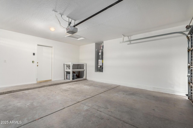 garage featuring baseboards, gas water heater, and a garage door opener