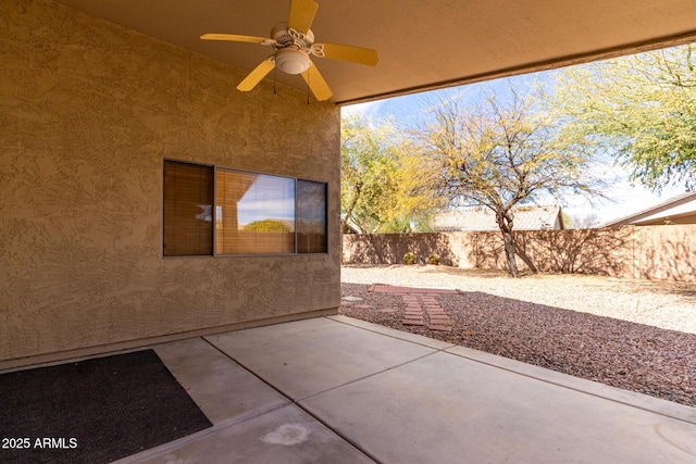 view of patio with a fenced backyard and a ceiling fan