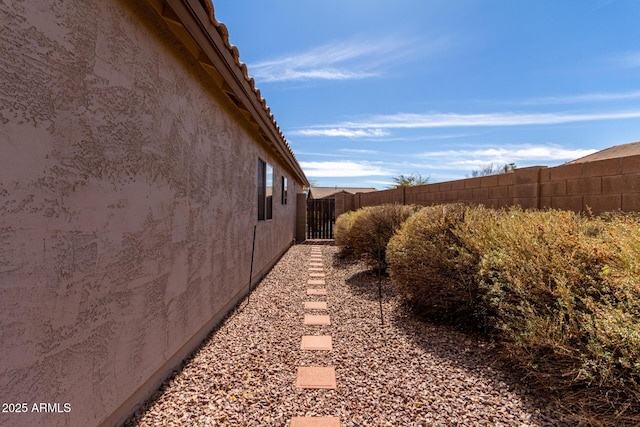 view of home's exterior featuring fence and stucco siding