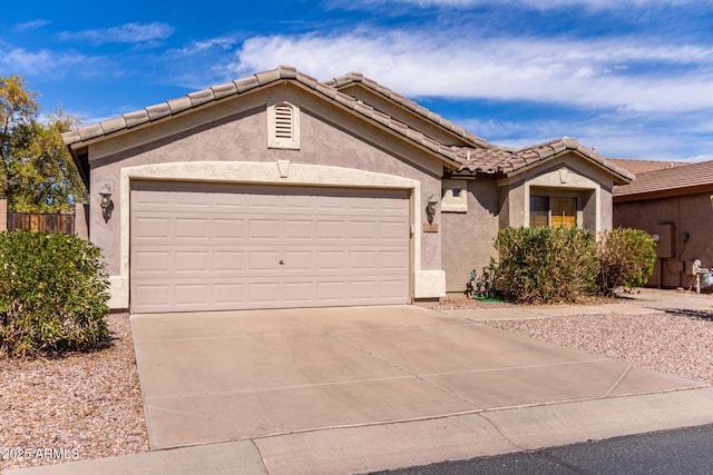 ranch-style house with a garage, a tiled roof, driveway, and stucco siding