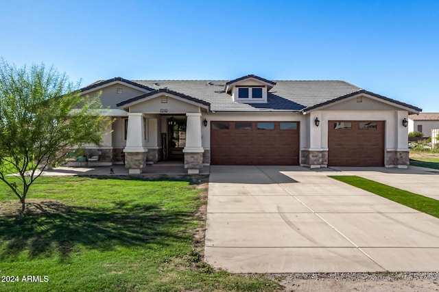 view of front facade featuring a front lawn and a garage