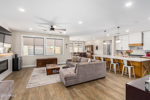 living room featuring hardwood / wood-style floors and ceiling fan