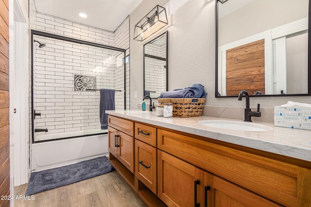 bathroom with vanity, enclosed tub / shower combo, and wood-type flooring