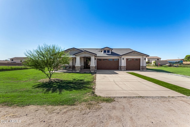 view of front of property featuring a front lawn and a garage