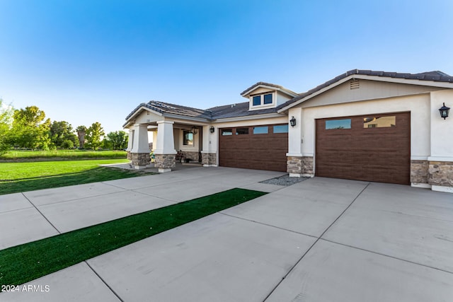 view of front of property with a garage and a front lawn