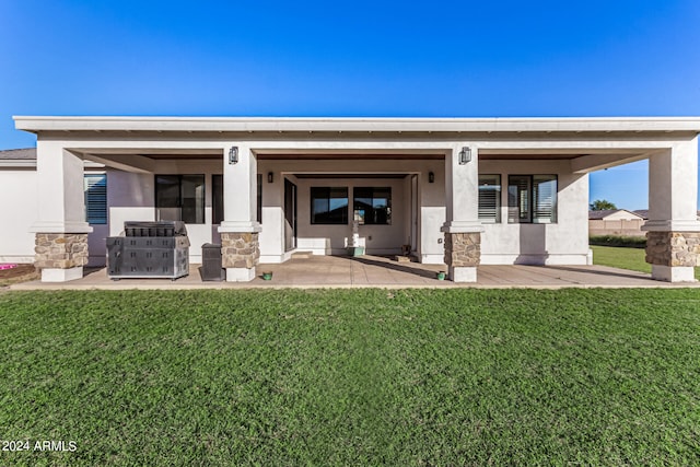 back of property featuring a yard and a porch