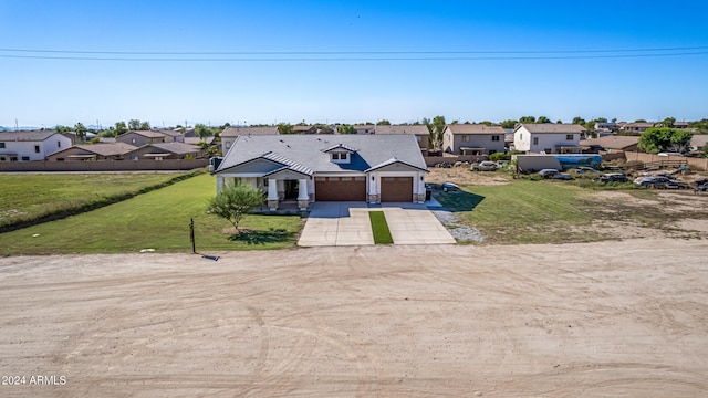 view of front of property featuring a front lawn and a garage