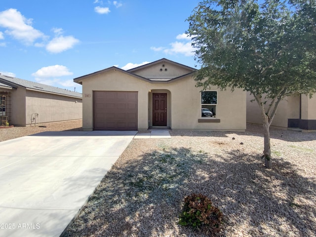 ranch-style house featuring stucco siding, driveway, and a garage
