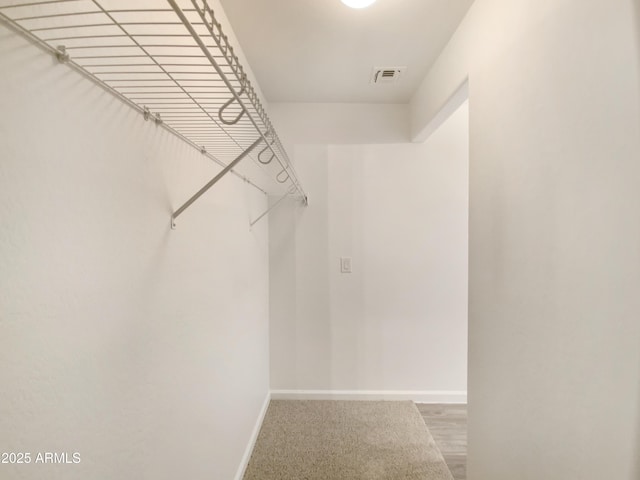 spacious closet featuring visible vents