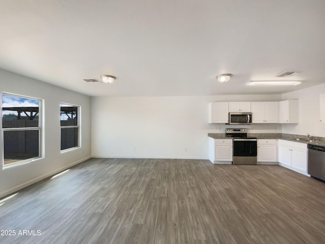 kitchen with visible vents, a sink, white cabinetry, and appliances with stainless steel finishes