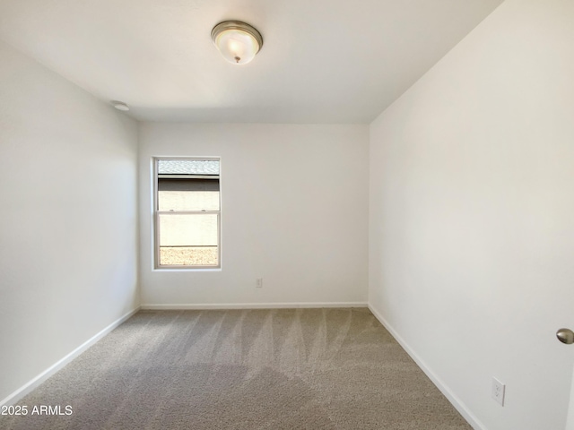 unfurnished room with baseboards and carpet