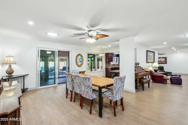 dining area featuring ceiling fan and light wood-type flooring