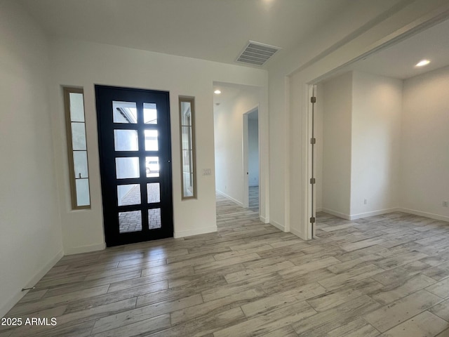 foyer entrance with light wood-type flooring