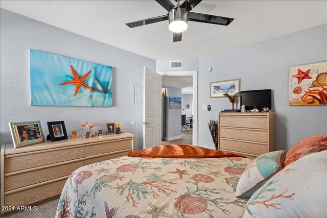 bedroom featuring ceiling fan and light carpet