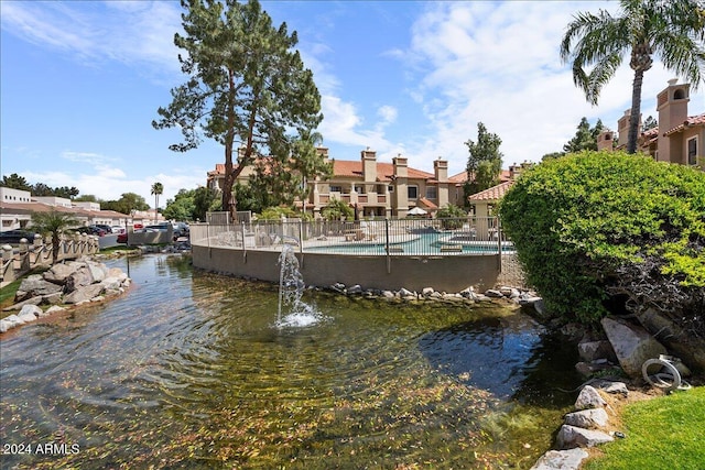 dock area with fence and a community pool