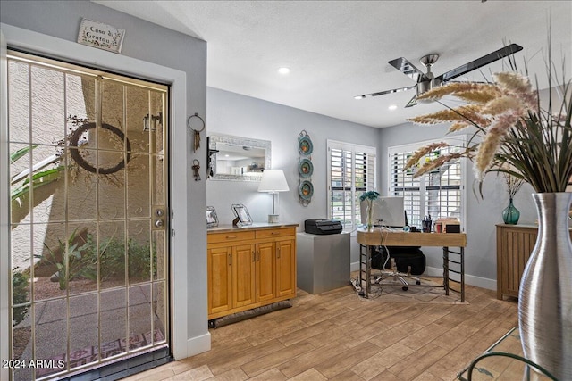 kitchen featuring ceiling fan, a textured ceiling, recessed lighting, baseboards, and light wood-type flooring