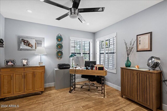 home office featuring ceiling fan and light hardwood / wood-style floors