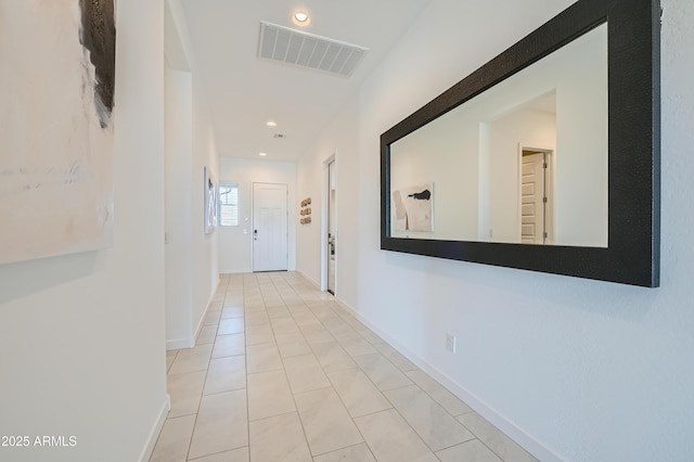 hall with recessed lighting, tile patterned floors, and baseboards